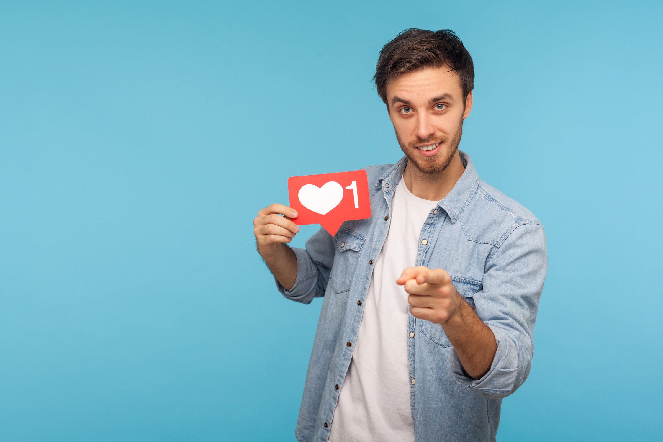 Portrait of Young Man with Instagram Like Sign